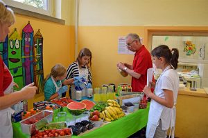 Die Grundschulkinder bereiten einen selbst kreierten Smoothie zu